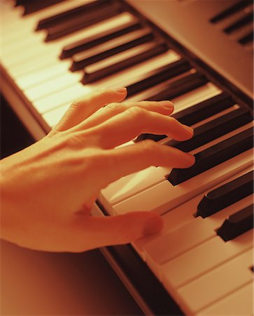 Close-Up of Hand Playing Piano Stock Photo - Rights-Managed, Code: 700-00042757