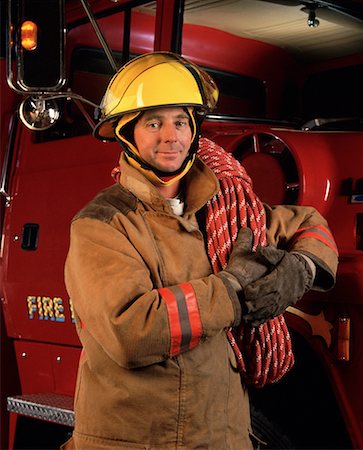 simsearch:700-00076137,k - Portrait of Fire Fighter Leaning On Fire Truck Foto de stock - Direito Controlado, Número: 700-00042839