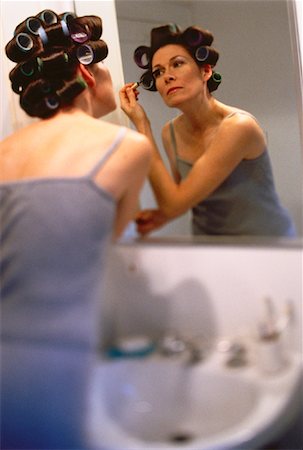 Woman Applying Make-Up in Mirror Stock Photo - Rights-Managed, Code: 700-00043519