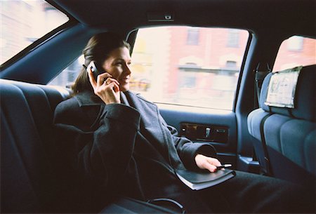 simsearch:700-00195272,k - Femme d'affaires utilisant un téléphone cellulaire en Taxi Photographie de stock - Rights-Managed, Code: 700-00043526