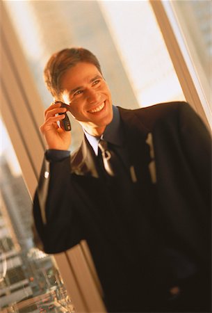 simsearch:700-00043555,k - Businessman Using Cell Phone Smiling Stock Photo - Rights-Managed, Code: 700-00043553