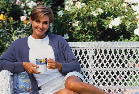 Portrait of Mature Woman Sitting In Chair, Holding Mug Outdoors Stock Photo - Rights-Managed, Code: 700-00054099