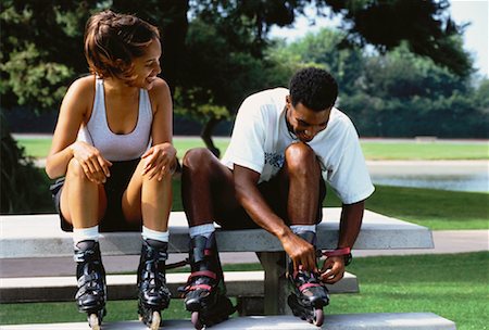 Couple Sitting on Picnic Table Wearing In-Line Skates Stock Photo - Rights-Managed, Code: 700-00054746