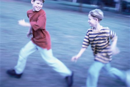 Two Boys Running in Field Fotografie stock - Rights-Managed, Codice: 700-00055242