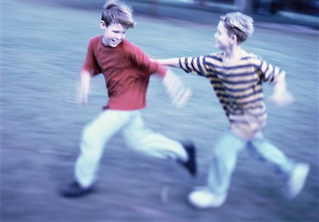 Two Boys Playing Tag in Field Fotografie stock - Rights-Managed, Codice: 700-00055243