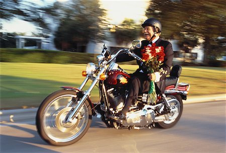 Mature Man Riding Motorcycle Carrying Bouquet of Flowers Foto de stock - Con derechos protegidos, Código: 700-00055370