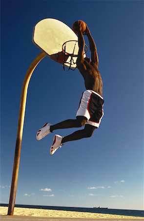 Man Slam Dunking Basketball Outdoors Stock Photo - Rights-Managed, Code: 700-00055509