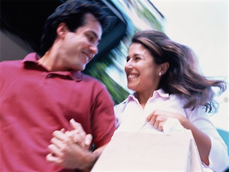 simsearch:700-00086311,k - Couple Walking on Street Carrying Shopping Bags Stock Photo - Rights-Managed, Code: 700-00055529