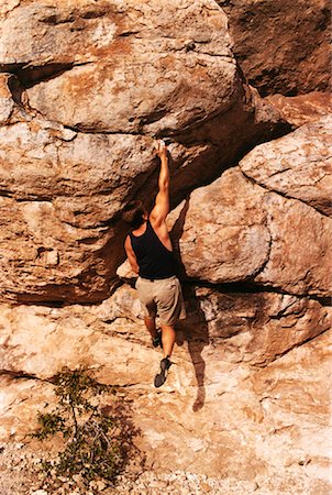 reaching out cliff - Back View of Man Rock Climbing Stock Photo - Rights-Managed, Code: 700-00055523