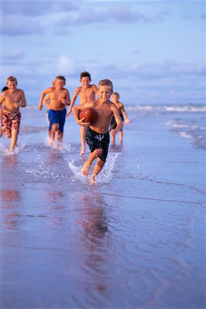 Group of Boys in Swimwear Playing Football on Beach Stock Photo - Rights-Managed, Code: 700-00055537