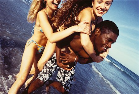 Three Teenagers in Swimwear Playing Football on Beach Stock Photo - Rights-Managed, Code: 700-00055546