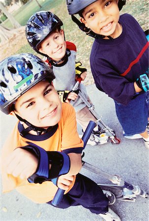 sports scooters - Portrait of Three Boys with Scooters on Sidewalk Foto de stock - Con derechos protegidos, Código: 700-00055632