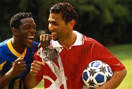 simsearch:700-00048635,k - Two Male Soccer Players, Covered In Mud, Laughing Foto de stock - Con derechos protegidos, Código: 700-00055652