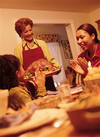 Grandmother Bringing Turkey to Thanksgiving Dinner Table Stock Photo - Rights-Managed, Code: 700-00055665