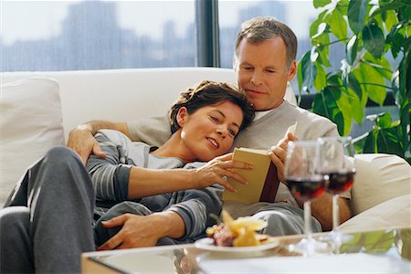 Mature Couple Relaxing on Sofa With Book, Wine and Cheese Stock Photo - Rights-Managed, Code: 700-00055929