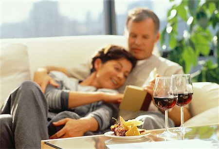 Mature Couple Sitting on Sofa With Wine and Cheese on Table Stock Photo - Rights-Managed, Code: 700-00055931