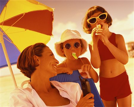 Mother Holding Cell Phone and Daughters Using Kazoos on Beach Stock Photo - Rights-Managed, Code: 700-00055984