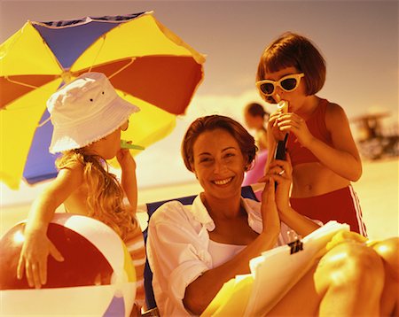 Mother Holding Cell Phone and Daughters Using Kazoos on Beach Stock Photo - Rights-Managed, Code: 700-00055980