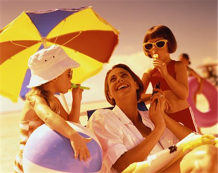 Mother Holding Cell Phone and Daughters Using Kazoos on Beach Stock Photo - Rights-Managed, Code: 700-00055982