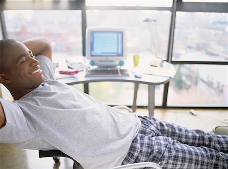 Man Sitting in Chair, Relaxing Near Computer Stock Photo - Rights-Managed, Code: 700-00056027