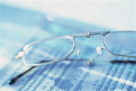 simsearch:600-02886550,k - Close-Up of Eyeglasses on Stock Listings Stock Photo - Rights-Managed, Code: 700-00056045