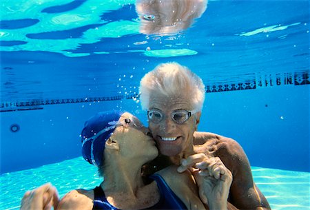 Mature Woman Kissing Mature Man Underwater in Swimming Pool Stock Photo - Rights-Managed, Code: 700-00056071