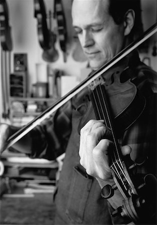 Luthier Playing Violin in Workshop Stock Photo - Rights-Managed, Code: 700-00056864