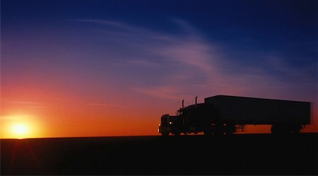 side view of a semi truck - Silhouette of Transport Truck on Road at Sunset Stock Photo - Rights-Managed, Code: 700-00057239