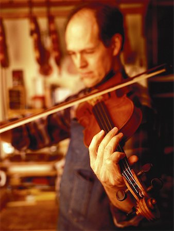 Luthier Playing Violin in Workshop Stock Photo - Rights-Managed, Code: 700-00057324