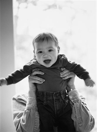 Mother Holding Child in Front of Face Fotografie stock - Rights-Managed, Codice: 700-00057503