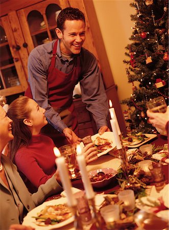 Father Serving Christmas Dinner To Family Foto de stock - Con derechos protegidos, Código: 700-00057514