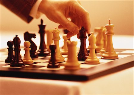 simsearch:700-00284729,k - Hand Lifting Chess Piece Foto de stock - Con derechos protegidos, Código: 700-00057805