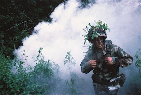 pictures of soldier with camouflage face paint - Soldier Wearing Camouflage Emerging from Smoke in Jungle Stock Photo - Rights-Managed, Code: 700-00057822