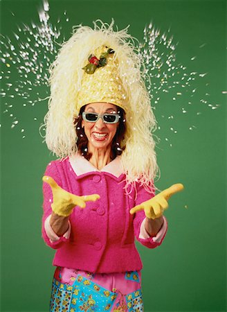 Portrait of Mature Woman Wearing Hat and Glasses Throwing Confetti Stock Photo - Rights-Managed, Code: 700-00057846