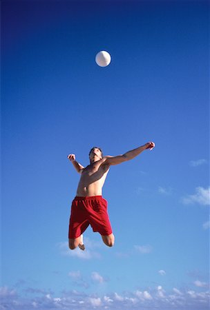 Male Volleyball Player Jumping To Hit Ball Stock Photo - Rights-Managed, Code: 700-00058076