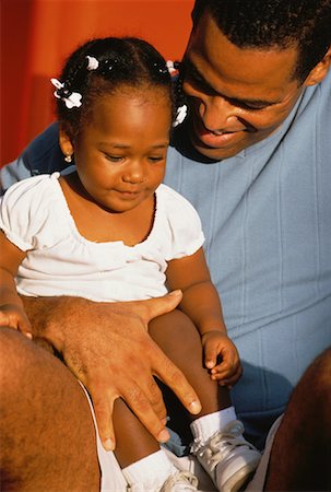 Father with Daughter Sitting in Lap Outdoors Stock Photo - Rights-Managed, Code: 700-00058199