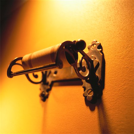 Empty Roll of Toilet Tissue on Wrought Iron Dispenser Fotografie stock - Rights-Managed, Codice: 700-00058232