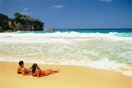 Back View of Couple in Swimwear Lying on Beach Dominican Republic, Caribbean Foto de stock - Con derechos protegidos, Código: 700-00058275