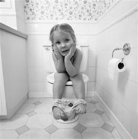 Portrait of Girl Sitting on Toilet Stock Photo - Rights-Managed, Code: 700-00058346