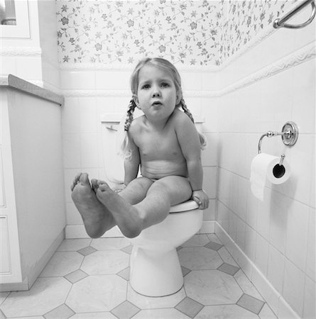 Portrait of Girl Sitting on Toilet Stock Photo - Rights-Managed, Code: 700-00058347