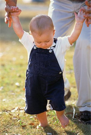 father and son overalls - Father Helping Child Walk Outdoors Stock Photo - Rights-Managed, Code: 700-00058719