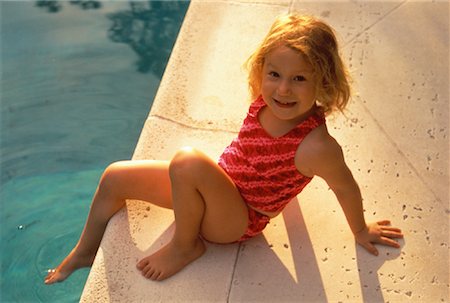 Portrait of Girl in Swimwear Sitting by Swimming Pool Stock Photo - Rights-Managed, Code: 700-00058951
