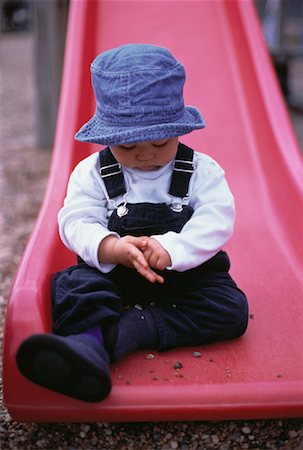 Portrait of Child Sitting on Slide Stock Photo - Rights-Managed, Code: 700-00058966