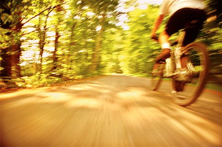 simsearch:700-00053390,k - Back View of Blurred Cyclist on Dirt Road Through Trees Foto de stock - Con derechos protegidos, Código: 700-00059026