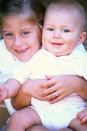 sister hugs baby - Portrait of Girl Holding Baby Stock Photo - Rights-Managed, Code: 700-00059424