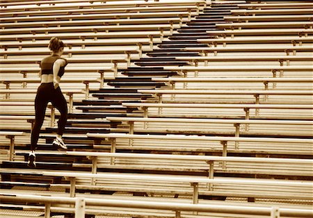 simsearch:700-00060793,k - Back View of Woman Running Up Steps in Stadium Stock Photo - Rights-Managed, Code: 700-00059674