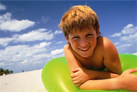 Portrait of Boy on Beach with Inner Tube, Miami Beach, Florida USA Stock Photo - Rights-Managed, Code: 700-00059818
