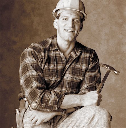 Portrait of Male Construction Worker Holding Hammer Stock Photo - Rights-Managed, Code: 700-00050475