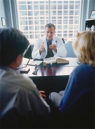 patient talking to office worker - Mature Couple in Doctor's Office Stock Photo - Rights-Managed, Code: 700-00050995