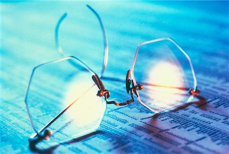 simsearch:600-02886550,k - Close-Up of Eyeglasses on Stock Listings Stock Photo - Rights-Managed, Code: 700-00051169